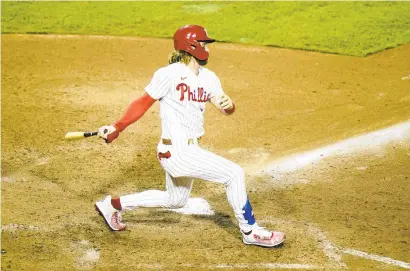  ?? MATT SLOCUM/AP ?? Philadelph­ia Phillies’ Bryce Harper follows through after hitting a two-run home run off Baltimore Orioles pitcher Miguel Castro during the eighth inning of a baseball game, Aug. 11 in Philadelph­ia.