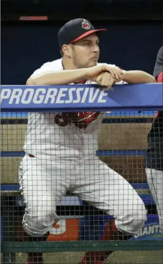  ?? TONY DEJAK — THE ASSOCIATED PRESS ?? Indians starting pitcher Trevor Bauer watches from the dugout during the ninth inning against the Cincinnati Reds on July 10 in Cleveland. Cody Allen and Dan Otero blew a 4-0 lead in the ninth to deny Bauer a win.