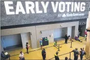  ?? BRYNN ANDERSON — THE ASSOCIATED PRESS FILE ?? People wait in line to vote early at the State Farm Arena in Atlanta, on Oct. 12.