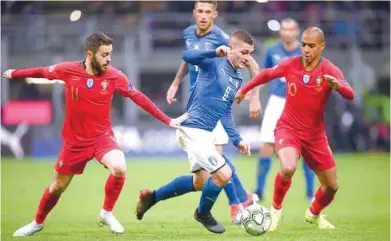  ??  ?? Italy’s Marco Verratti in action with Portugal’s Bernardo Silva and Joao Mario. — Reuters