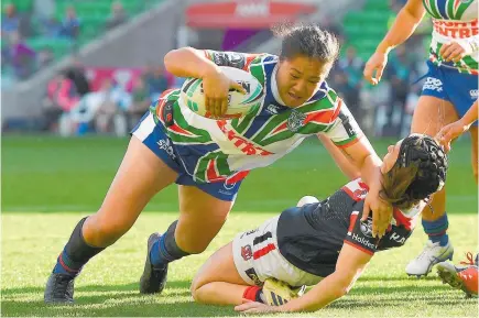  ?? Photo / Getty Images ?? Charntay Poko smashes past Roosters forward Hannah Southwell to score in the NRLW.