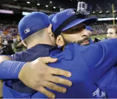  ?? PATRICK SEMANSKY/THE ASSOCIATED PRESS ?? The Jays’ Jose Bautista hugs a teammate after the team’s 15-2 demolition of the Orioles in the first game of a doublehead­er on Wednesday.