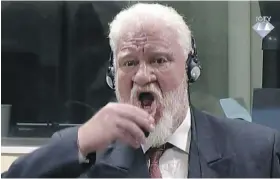  ??  ?? In these images from a video, Slobodan Praljak brings a bottle of poison to his lips and downs it during a Yugoslav war crimes tribunal Wednesday in The Hague, Netherland­s.