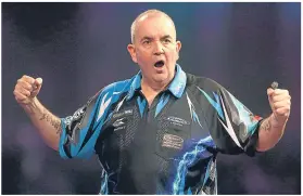  ??  ?? Phil ‘The Power’Taylor celebrates his win over Kim Huybrechts.