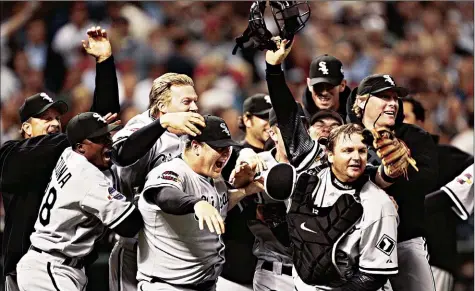  ?? By H. Darr Beiser, USA TODAY ?? It’s party time:
White Sox players pile onto the ; eld and each other after securing the ; nal out of Game 4 on Wednesday night to complete a World Series victory.