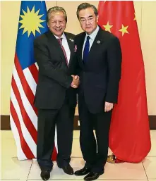  ??  ?? Working together: Chinese Foreign Minister Wang Yi and Anifah posing for a photo prior to their bilateral meeting on the sidelines of the 50th Asean Regional Forum in Manila earlier this month.