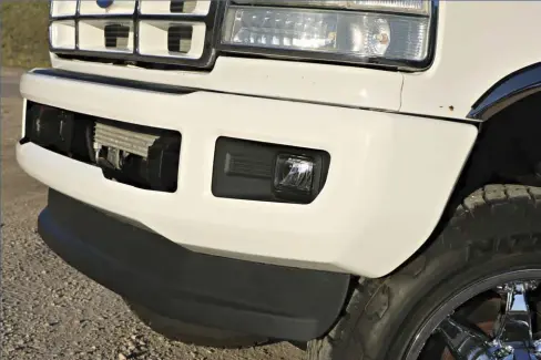  ??  ??  To update the old girl a bit, Gibson found a take-off 2017 F-250 chrome bumper that he had powdercoat­ed white to match the rest of the truck. With some custom front brackets, this new-body-style bumper looks like it belongs on that old body style truck.