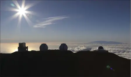  ?? CALEB JONES — THE ASSOCIATED PRESS ?? The sun sets behind telescopes at the summit of Mauna Kea, Hawaii’s tallest mountain in 2019. A volcano on Hawaii’s Big Island is sacred to spiritual practition­ers and treasured by astronomer­s.