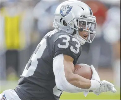  ?? Ben Margot The Associated Press ?? DeAndré Washington, above, and Jalen Richard are expected to shoulder the load at running back for the Raiders against the Chargers on Sunday with Josh Jacobs out with a shoulder injury.