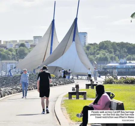  ?? ROB BROWNE ?? People walk across Cardiff Bay barrage yesterday – on the first day the five-mile travel restrictio­n was lifted in Wales