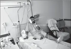  ?? AP Photo/Alvaro Barrientos ?? Hospital: Jaime Alvarez from Santa Clara County, California, sits in a hospital in Pamplona, northern Spain, Monday, July 8, 2019 after being gored by a bull Sunday at the San Fermin Festival. Alvarez, a 46-year-old who works as a public defender in Santa Clara County, California, says that being ran over and gored in the neck by a bull is something he will never forget. “The joy and the excitement of being in the bullring quickly turned into scare, into real fear for my life,” the San Francisco resident told The Associated Press on Monday at the regional hospital where he recovered a day after undergoing an urgent 2-hour-long surgery.