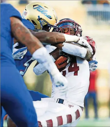  ?? WARDARSKI/TULSA WORLD VIA AP] [JESSIE ?? In this Nov. 25, 2017, file photo, Temple’s David Hood, right, is tackled by the Tulsa defense during a game in Tulsa, Okla. Hood took the field one more time. The running back-turned-rapper performed at halftime on Thursday night at Lincoln Financial Field the new Temple sports anthem he wrote, called “Temple Made.”