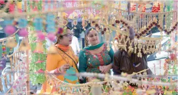  ?? — AFP ?? Shoppers look for decoration items for Diwali, in Amritsar on Tuesday.