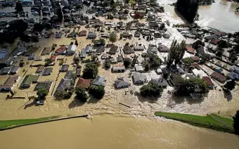  ?? CHRIS MCKEEN/STUFF ?? Receding floodwater­s revealed the damage to Edgecumbe in the Bay of Plenty after a flood bank was breached in April 2017.