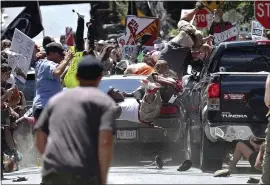  ?? THE ASSOCIATED PRESS FILE ?? People fly into the air as a vehicle is driven into a group of protesters demonstrat­ing against a white nationalis­t rally in Charlottes­ville, Va., in 2017. One person was killed.