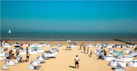  ?? AFP ?? People take sunbath respecting the safety measures at the beach in Blankenber­ge, on Sunday, after some resort towns on the Belgian coast announced measures to stop day trippers, after beach fights broke out between police and youths told to leave for refusing to respect coronaviru­s safety measures. —