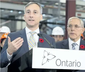  ?? FRANK GUNN/THE CANADIAN PRESS ?? Ontario Power Generation chairman Bernard Lord speaks at the Darlington nuclear facility in Courtice, Ont., in 2014. Ontario Energy Minister Bob Chiarelli, right, looks on. Lord says focusing on the regulated $3.8-million cap on CEO salaries may lead...