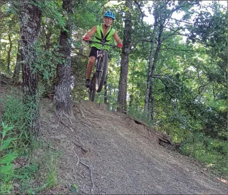  ?? (Special to the Democrat-Gazette/Nancy Raney) ?? Bob Robinson records himself while biking the fast-downhill sections of Ben Green Park’s bike trails at Fort Smith as part of his lockdown project, making a movie to enter in a contest.