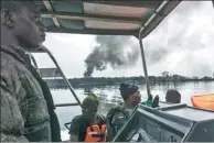  ?? STEFAN HEUNIS / AGENCE FRANCE-PRESSE ?? Members of the Nigerian Navy on patrol looking for illegal oil refineries in the Niger Delta region near the city of Port Harcourt.