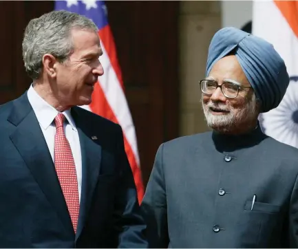  ?? (Reuters) ?? US PRESIDENT George W. Bush walks with India’s then-prime minister Manmohan Singh to a joint news conference at Hyderabad House in New Delhi in 2006.