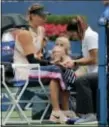  ?? ANDRES KUDACKI — THE ASSOCIATED PRESS ?? A trainer wraps a finger on Maria Sharapova’s hand between games against Anastasija Sevastova Sunday in New York.