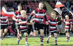 ??  ?? Captain Jonny Hope leads out the team with mascots