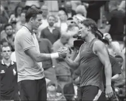  ?? The Associated Press ?? EARLY ENDING: Juan Martin del Potro, left, shakes hands with Rafael Nadal Friday after Nadal retired from their U.S. Open semifinal match in New York.