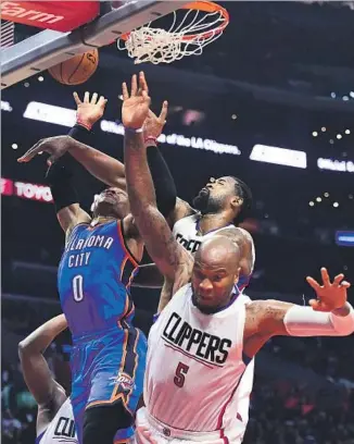  ?? Harry How Getty Images ?? CENTER DeAndre Jordan had a big hand in Clippers’ easy win, and a hand in Russell Westbrook’s face in the first half. Jordan finished with 19 points, 15 rebounds and four blocks, including this one.