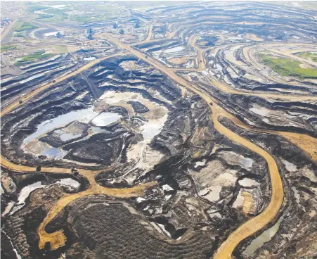 ?? POSTMEDIA NEWS FILES ?? Canadian Natural, whose oilsands mining site is seen near Fort McKay, Alta., has a market capitaliza­tion of over $25 billion.