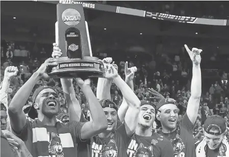  ?? BRETT DAVIS/USA TODAY SPORTS ?? The Loyola Ramblers celebrate with the trophy representi­ng their South Region championsh­ip.