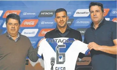  ?? NA ?? Fernando Gago (centre) holds up a Vélez shirt at his presentati­on ceremony.