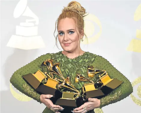  ??  ?? ADELE won five Grammys on a record-breaking night for the British star, but she was left “devastated” after fluffing her musical tribute to George Michael.
The 28-year-old singer won album of the year for 25 and record and song of the year for Hello,...