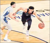  ?? Sarah Stier / Getty Images ?? UConn’s James Bouknight dribbles around Creighton’s Marcus Zegarowski during Saturday’s Big East semifinal at Madison Square Garden.