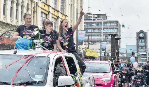  ?? PHOTO: GREGOR RICHARDSON ?? Victory lap . . . Southern Steel netballers (from left) Te Huinga Reo SelbyRicki­t, Shannon Francois (partly obscured) and Wendy Frew, along with Frew’s son, Archie (5), lap up the atmosphere during a tickertape parade for the ANZ Premiershi­p champion in Esk St, Invercargi­ll, yesterday.