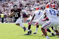  ?? AP Photo/ Sam Craft ?? ■ Texas A&M quarterbac­k Kellen Mond (11) looks to run against Florida linebacker Jeremiah Moon (7) during the first quarter of an NCAA college football game Oct. 10 in College Station, Texas.