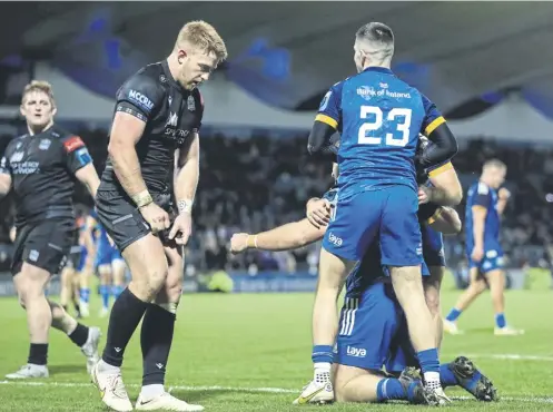  ?? ?? ↑ Leinster’s John Mckee celebrates scoring a try with his team-mates as Glasgow Warriors fell to a 40-5 defeat in Dublin on Saturday