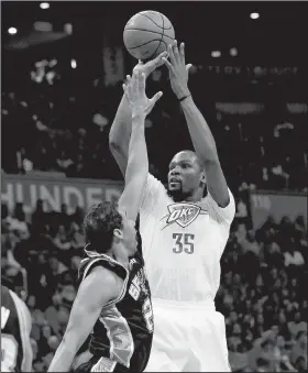  ?? AP/SUE OGROCKI ?? Oklahoma City Thunder forward Kevin Durant, right, shoots Saturday over San Antonio Spurs guard Andre Miller, left, in the second quarter of an NBA basketball game in Oklahoma City.