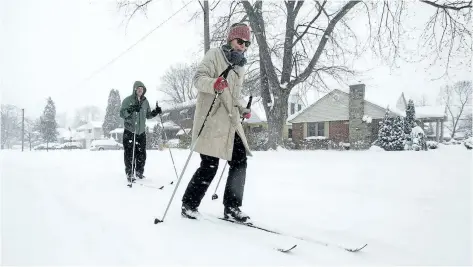  ?? JULIE JOCSAK/STANDARD STAFF ?? Mark Shantz gives Brianna Bosgraaf a crash course in skiing on South Drive in St. Catharines on Tuesday, during winter’s heaviest snowfall of the season. Spring officially arrives next Monday.