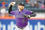  ?? Adam Hunger / Associated Press ?? Adam Ottavino, a right-handed relief pitcher shown here with Colorado last season, signed a $27 million, three-year contract with the Yankees.