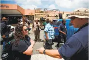  ?? Michael Nagle / Bloomberg ?? U.S. Virgin Islands Gov. Kenneth Mapp (center, in light blue shirt) accesses damage on St John island.