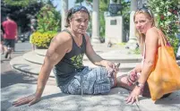  ??  ?? Alex Stratakos and Tina Cyr visited the makeshift memorial for the Danforth shooting victims on Saturday.