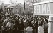  ?? Roberto Schmidt / AFP via Getty Images file ?? A large crowd marches down the streets of Selma, Ala., several years ago while re-creating the peaceful 1965 voting rights march that ended in violence.