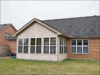  ??  ?? A Florida room has an oak floor, 6 sets of windows with blinds, ceiling paddle fan and a glass door that opens to a semi-private concrete patio and open backyard.