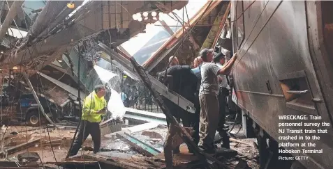  ?? Picture: GETTY ?? WRECKAGE: Train personnel survey the NJ Transit train that crashed in to the platform at the Hoboken Terminal
