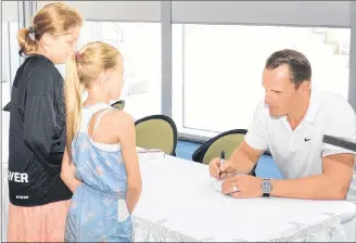  ?? JASON SIMMONDS/JOURNAL PIONEER ?? Los Angeles Kings defenceman Dion Phaneuf signs autographs for young fans following a major announceme­nt at Credit Union Place on Wednesday. It was announced the National Hockey League Players Associatio­n (NHLPA) Goals and Dreams Fund was donating 25 sets of brand-new hockey equipment for first-time participan­ts between the ages of 11-to 13-years-old in Summerside during the 2018-19 season. Phaneuf, who spends his summers on P.E.I., was a driving force behind this promotion.