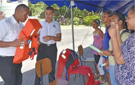  ?? Photo: ?? Fiji Maritime Academy students explaining live jacket usage procedures to the students of Stella Maris Primary School during the College of Engineerin­g, Science and Technology Exhibition at FNU Derrick Campus, Samabula.