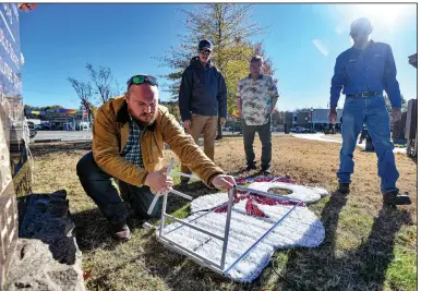  ?? Valley Democrat-Gazette/Hank Layton) ?? Casey Craig (from left), director of Greenwood’s Parks and Recreation Department, along with Jones, Mark Huneycutt and Tucker, helps set up holiday displays in downtown.
(River