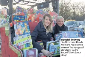  ??  ?? Special delivery Staff from Monklands Women’s Aid received some of the toy appeal donations via the Round Table’s Santa sleigh