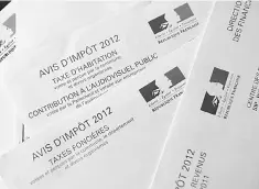  ??  ?? This file photo shows a housing tax form and a property tax form.The reform on the housing tax, one of French President’s election promise, will come into effect in 2018, according to a source in Bercy on July 10. — AFP photo