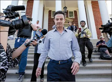  ?? AP/The Courier-Journal/MICHAEL CLEVENGER ?? Louisville men’s basketball Coach Rick Pitino leaves Grawemeyer Hall after having a meeting with the university’s interim president Greg Postel on Wednesday in Louisville, Ky. The school announced Wednesday that it has placed Pitino and Athletic Director Tom Jurich on administra­tive leave amid a federal bribery investigat­ion.